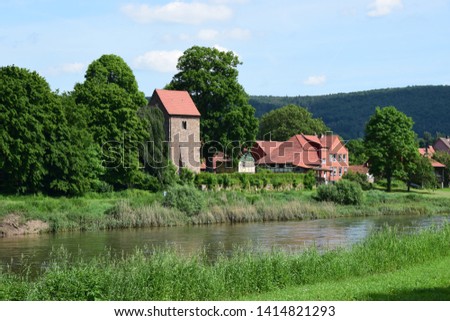 The idyllic village Hemeln at the river Weser with medieval church tower