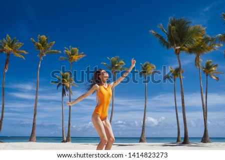 Pretty woman sun tanning beach palm trees vacation fun trip