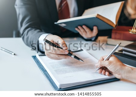 Businessman and lawyer discuss the contract document. Treaty of the law. Sign a contract business. Royalty-Free Stock Photo #1414855505