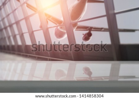 Table background of free space for your decoration and airport background with window and plane. Summer sunset and travel time. 