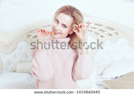 Young smiling woman holds bitcoin coins in her hands.