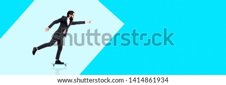 bearded businessman riding a skateboard, man pointing finger on copy space, panoramic image