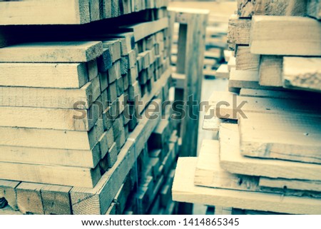 wood lumbers logs ready to use in industry stockpiled in warehouse