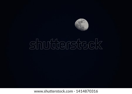 Small moon in night sky (top)