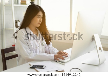 Asian female doctor work at hospital office desk giving patient convenience online service advice, smiling write a prescription order medical with smartphone, health care, preventing disease concept.
