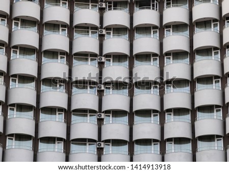 Background texture of balconies and windows of the hotel. The wall of the hotel with balconies and windows.