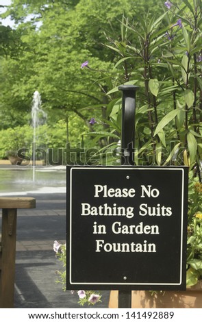 Sign to discourage playing in fountain of formal garden