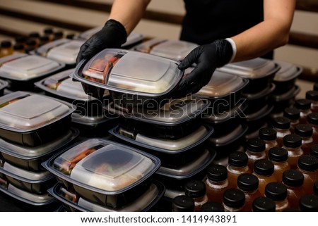 Lunch box with food in the hands. Catering Royalty-Free Stock Photo #1414943891