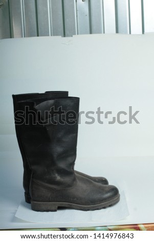 black tarpaulin boots on a white background