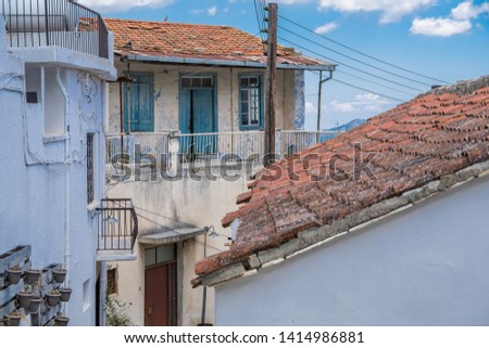 Tiled roofs of Cypriot village Lefkara. Several houses over a background of blue summer sky. Travels and vacation concept.
