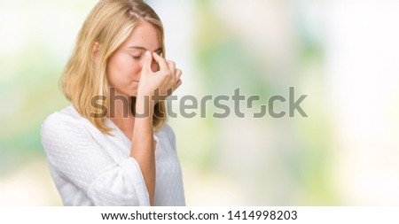 Beautiful young elegant woman over isolated background tired rubbing nose and eyes feeling fatigue and headache. Stress and frustration concept.