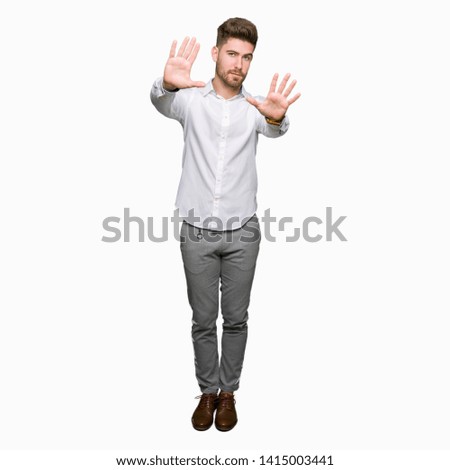 Young handsome business man Smiling doing frame using hands palms and fingers, camera perspective