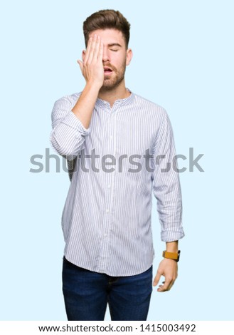 Young handsome man Yawning tired covering half face, eye and mouth with hand. Face hurts in pain.