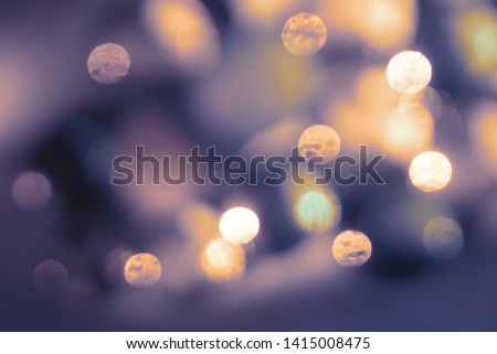 Violet and orange abstract background with blurred lights.