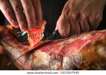 Dry Spanish ham, Jamon Serrano, Bellota, Italian Prosciutto Crudo or Parma ham, whole leg isolated on black background Royalty-Free Stock Photo #1415047940