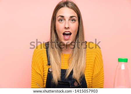 Young woman with bowl of cereals with surprise facial expression