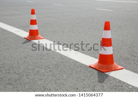 road striped cones on asphalt. 