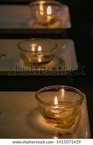 Lit oil lamps at a Buddhist center in Colombo, Sri Lanka