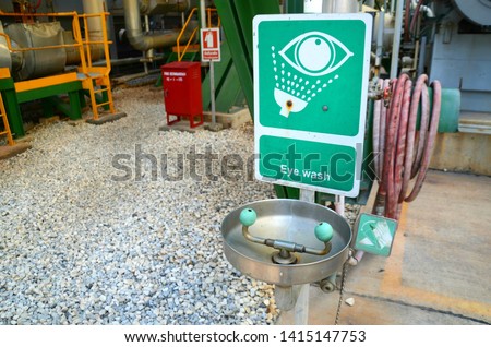 Eye wash station or equipment for workers when an emergency has chemicals in the eyes to first aid. That is installed in a chemical plant and signs installed to indicate.