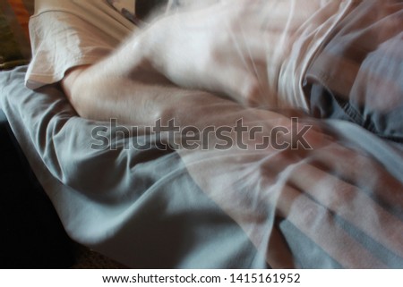 Outer body experience of ghost hand leaving body Royalty-Free Stock Photo #1415161952