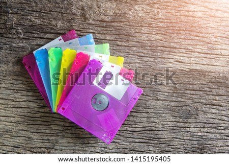 Floppy disks on a wooden table background.