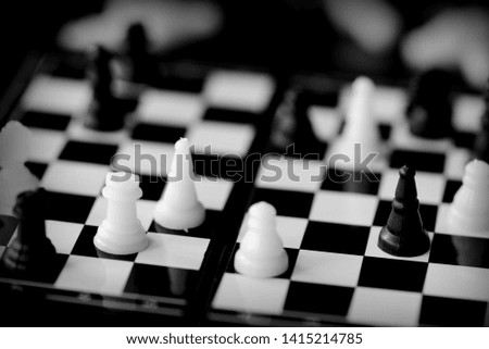Travel Chess on a dark background close up. Black and white