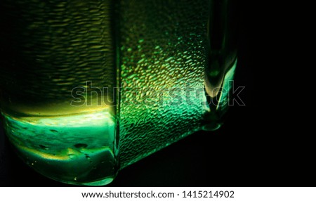 Green bottom parts of a bottle with black background photo