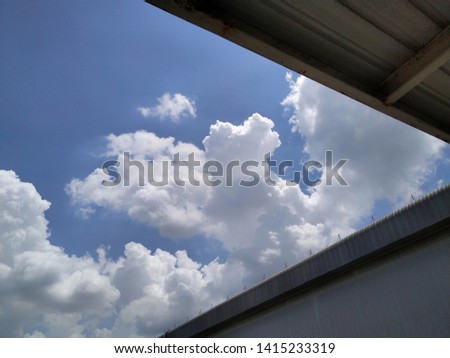view under roof, blue sky background with tiny clouds
