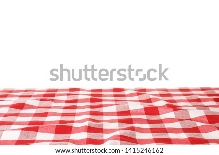 Table with red checkered cloth isolated on white