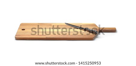 Stainless steel carving knife with plastic handle on board against white background