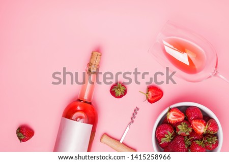 Creative composition with rose wine and delicious strawberries on the pink background, top view Royalty-Free Stock Photo #1415258966