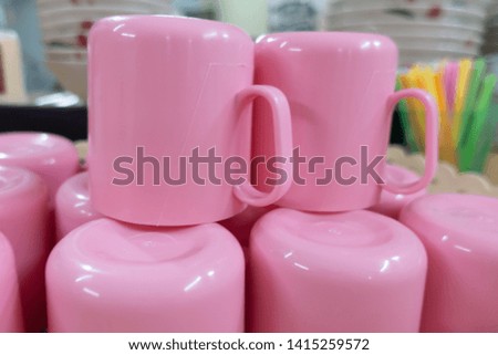Pink plastic cups in the basket ready to use