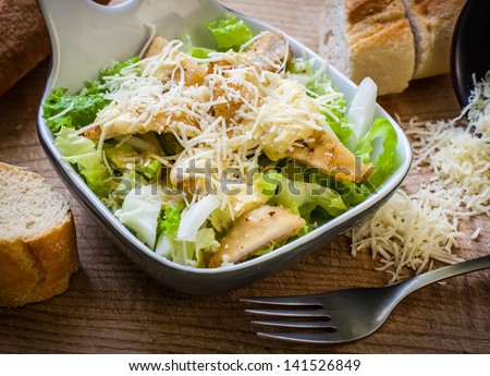 fresh caesar salad on bowl with parmesan cheese Royalty-Free Stock Photo #141526849