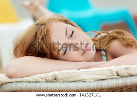 Portrait of a sleeping young woman in deck chair