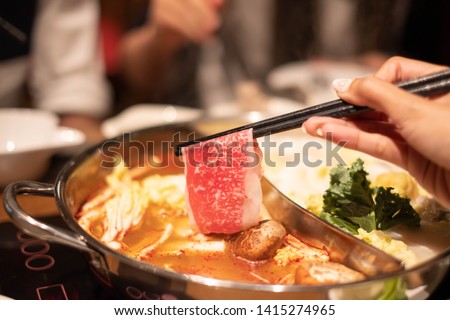 Ma La Hotpot, Spicy Chinese hot pot with beef, tofu, prawns, mushrooms, green leaves and noodles.