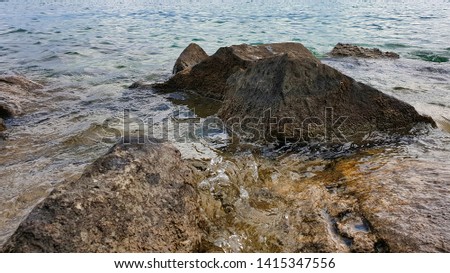 Close-up of the rocks protruding from Lake Zurich near seaside resort Risi in Uerikon.