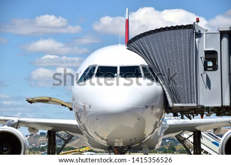 Front picture of an airplane loading passengers before take off