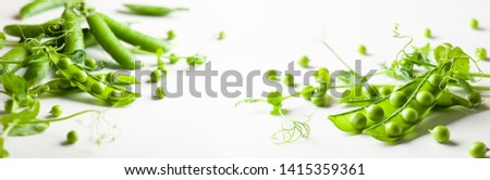 Fresh green  peas pods and  green peas with  sprouts on white wooden background. Concept of healthy eating, fresh vegetables. Royalty-Free Stock Photo #1415359361