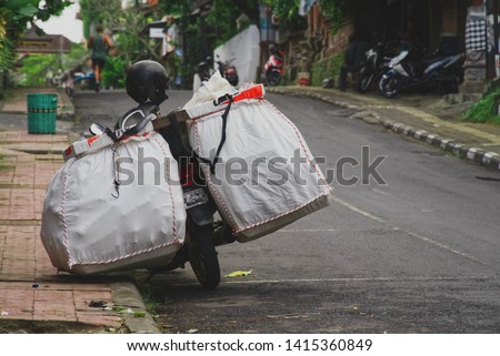Motorcycle parking on a road near the sidewalk in Ubud, Bali