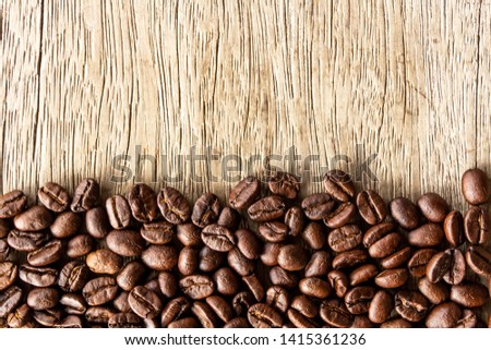 Flame with Coffee beans on old wood background