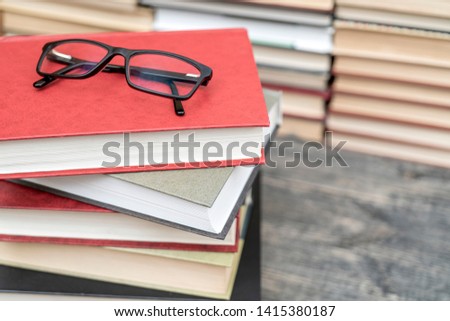 Glasses on the background of books. Symbol of knowledge, science, study, wisdom.