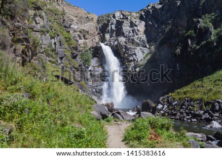 Waterfall in Altay mountains. Beautiful nature landscape. Popular touristic distination.