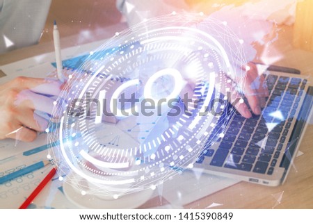 Crypto currency theme hologram with businessman working on computer on background. Concept of blockchain. Double exposure.
