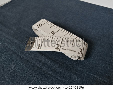 White Measuring Tape Isolated on Black Texture Background
