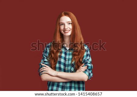 Because of your smile, you make life more beautiful. Portrait of cheerful pretty young lady smiling at the camera while standing with arms crossed