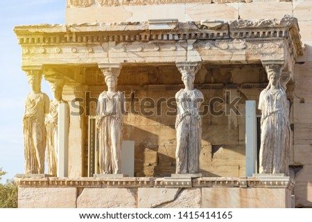 Detail photo of iconic Caryatids statues in porch of Caryatids located on top of Acropolis hill next to iconic masterpiece Parthenon, Athens historic center, Attica