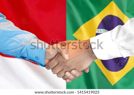 Business handshake on the background of two flags. Men handshake on the background of the Brazil and Monaco flag. Support concept