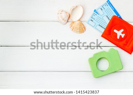Funny vocation concept with camera, passport and tickets on white wooden background top view space for text