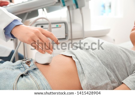 Woman undergoing ultrasound scan in clinic Royalty-Free Stock Photo #1415428904