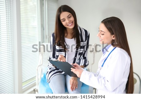 Female gynecologist working with patient in clinic Royalty-Free Stock Photo #1415428994
